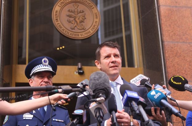 Premier Mike Baird (R) and New South Wales police commissioner Andrew Scipione (L) address the media outside the Lindt cafe in Sydney on December 15, 2015
