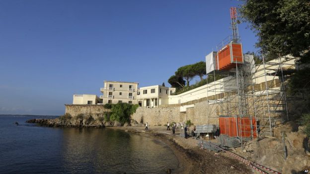 Workers setting up a temporary elevator on the public beach called 