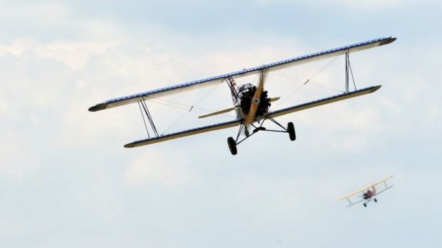 Vintage bi-planes fly at a low altitude over the Nairobi National Park while participating in the rally (27 November 2016)