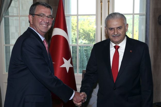 Turkey's Prime Minister Binali Yildirim, right, and US Secretary of Defense Ash Carter shake hands before a meeting in Ankara, Turkey, 21 October