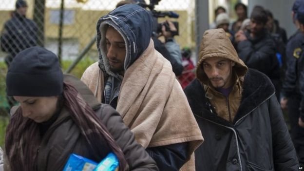 Migrants at Gruskovje, Slovenia, wait to be transferred by bus to Austria 17/10/2015