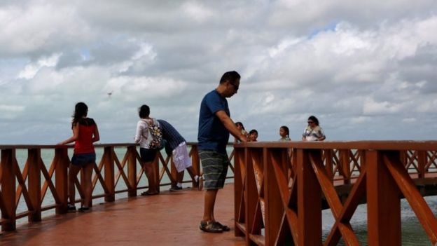 Tourists are seen on a board walk as Tropical Storm Earl approaches, in Chetumal in the state of Quintana Roo, Mexico (03 August 2016)