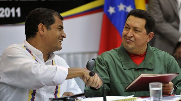 Venezuelan President Hugo Chavez and Ecuadorean President Rafael Correa shake hands at a summit