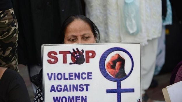 A protester holds a placards about violence against women in India