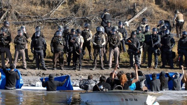 Dakota Access Pipeline protesters stand waist deep in the Cantapeta Creek, northeast of the Oceti Sakowin Camp, near Cannon Ball, N.D., Wednesday, Nov. 2, 2016.