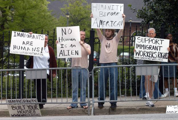 Counter-demonstrators display signs during an immigration rally on the steps of the state Capitol April 17, 2006 in Atlanta, Georgia.