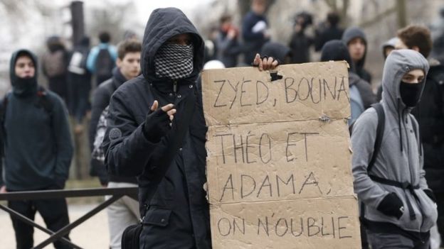 A youth holds a placard during the protests in Paris on Thursday (23 February 2017)