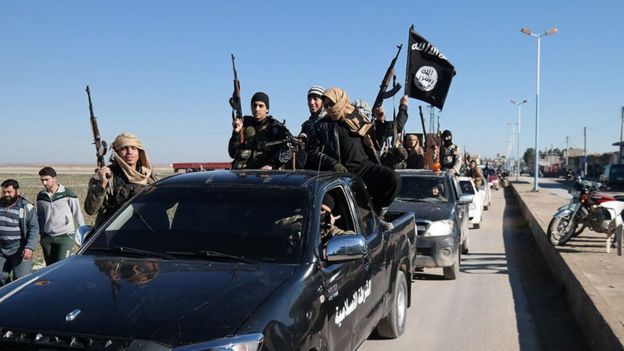 Photo released in May 2015, by a militant website, showing Islamic State militants pass by a convoy in northern Syria