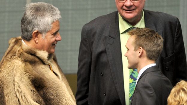 The first indigenous member of the House of Representatives Ken Wyatt (L) speaks to the youngest member Wyatt Roy (R) in the House of Representatives chamber at Parliament House Canberra, on Sept. 28, 2010 Canberra, Australia