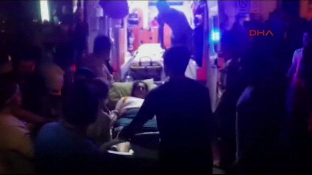 Injured woman on stretcher is put inside an ambulance