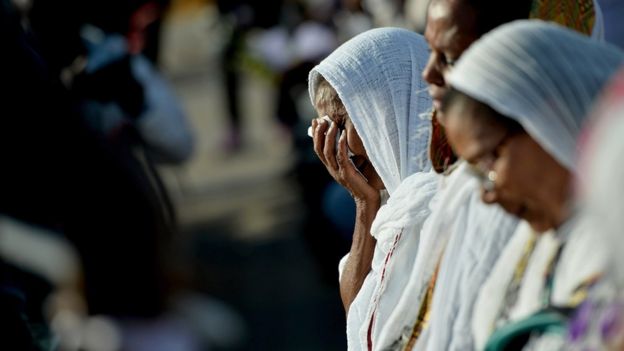 Eritrean people attend the commemoration ceremony for the victims of the boat sinking disaster off the Lampedusa coast on October 21, 2013 in San Leone near Agrigento, Italy