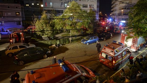 Emergency services work outside a nightclub in Bucharest, Romania