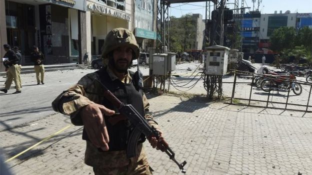A Pakistani soldier cordons off the site of a bomb attack in Lahore on February 23, 2017
