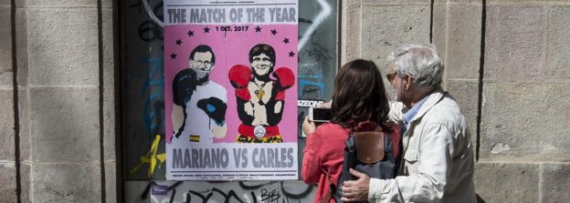 A poster showing Spanish Prime Minister Mariano Rajoy (L) and President of the Catalan Government Carles Puigdemont, on September 16, 2017 in Barcelona