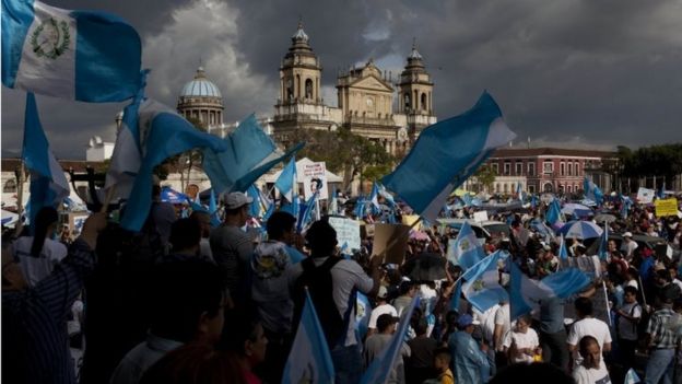Demonstrators gather outside the National Palace to protest corruption in Guatemala City, Saturday, June 11, 2016.