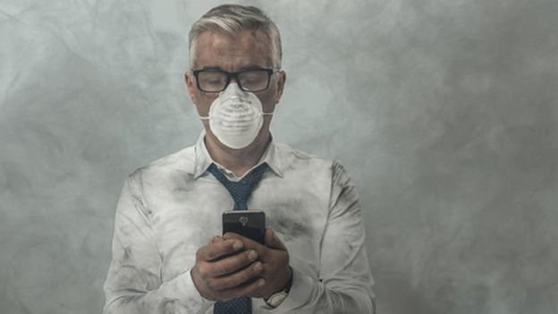 Homem com mascara e ar poluido em volta