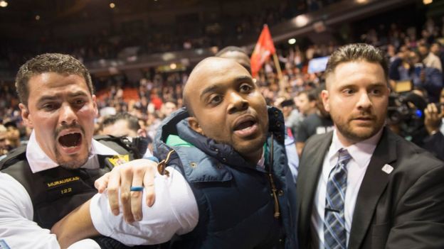 An activist is removed by police after it was announced that a rally with Republican presidential candidate Donald Trump at the University of Illinois at Chicago would be postponed on March 11, 2016 in Chicago, Illinois.