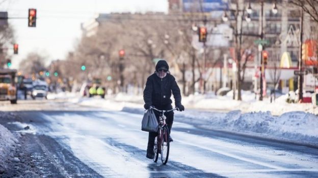 A man bikes down Broad Street in Philadelphia, Pennsylvania (24 January 2016)