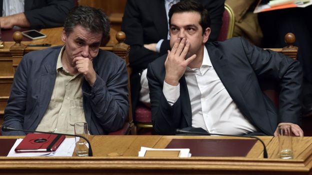 Greek Prime Minister Alexis Tsipras (R) and Finance Minister Euclid Tsakalotos react during a parliament session in Athens on July 15, 2015.