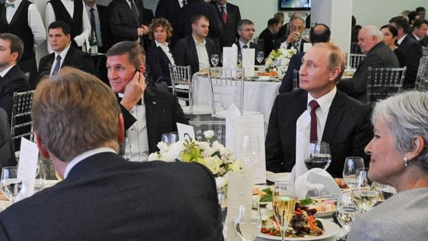 In this file photo taken on 10 December 2015, Russian President Vladimir Putin is seen centre right with retired US Lt Gen Michael Flynn, centre left