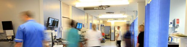 File photo from 2014 showing staff walking around a hospital ward corridor.