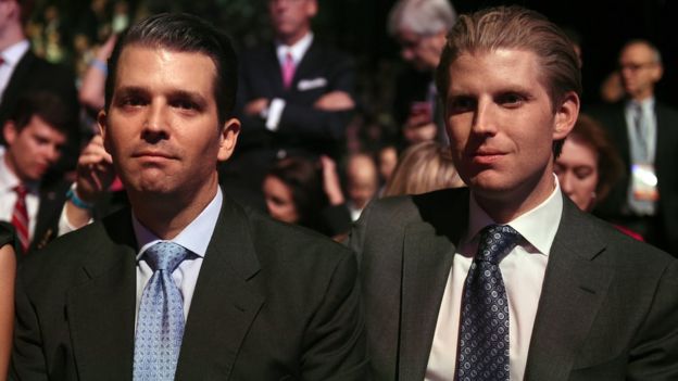 Donald Trump's sons Eric Trump (L) and Donald Trump Jr. wait for the start of the CNBC Republican Presidential Debate, October 28, 2015