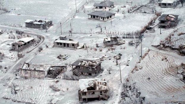 Picture taken on 27 June 1997 showing destroyed houses on the northeast part of Montserrat island after the eruption of the Soufriere Hills volcano.