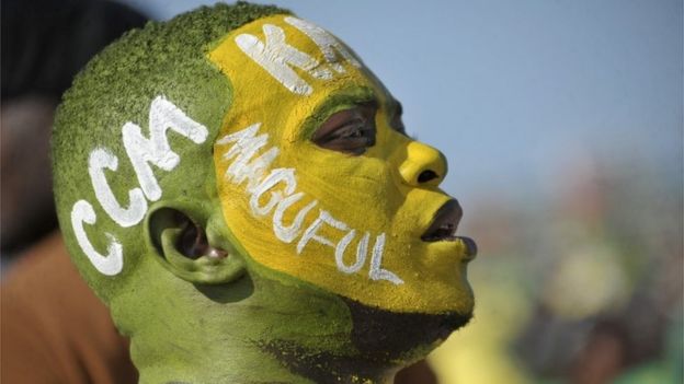 A supporter wears facepaint on which is written the initials of the ruling Chama Cha Mapinduzi (CCM) party, and the surname of their presidential candidate John Magufuli, at an election rally in Dar es Salaam, Tanzania Friday, Oct. 23, 2015