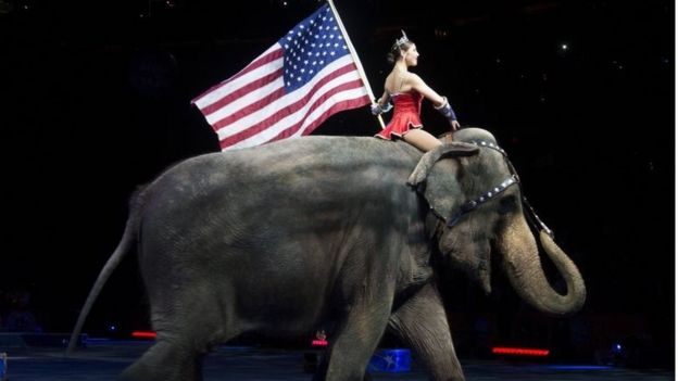 A performer riding an elephant holding a US national flag during a Ringling Bros. and Barnum and Bailey Circus performance in Washington DC on 19 March 2015