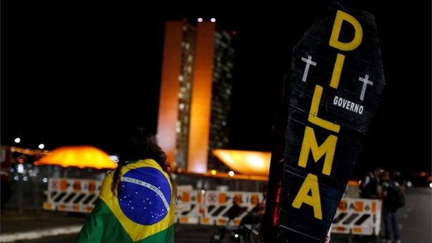 A pro-impeachment demonstrator holds a cardboard coffin painted with the name of Dilma Rousseff during a protest in front of the National Congress, in Brasilia, Brazil, August 30, 2016