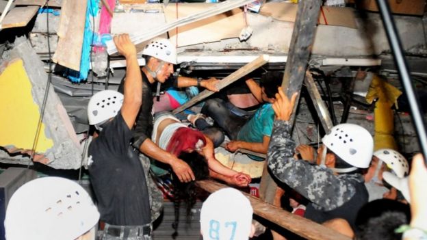 Two survivors are pulled from a collapsed building in the city of Manta, 17 April