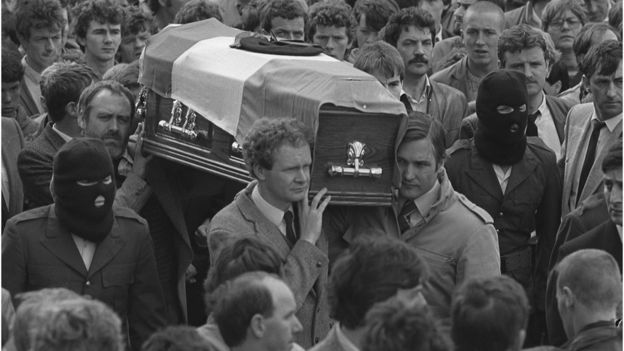 Martin McGuinness front left and Martin Galvin (front right) carry coffin of Chuck English, at an IRA funeral in Derry, August 1985