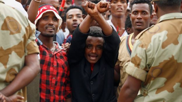 Demonstrators chant slogans while flashing the Oromo protest gesture during Irreecha, the thanksgiving festival of the Oromo people, in Bishoftu town, Oromia region, Ethiopia, 2 October 2016.