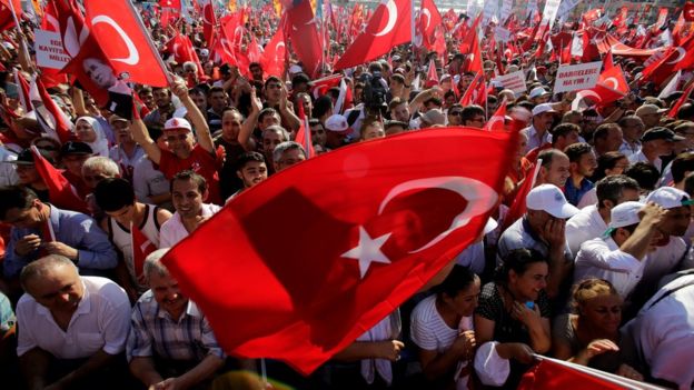A supporter of the Republican People's Party, or CHP, waves a Turkish flag bearing a portrait of Mustafa Kemal Ataturk, the founder of modern Turkey, during a 