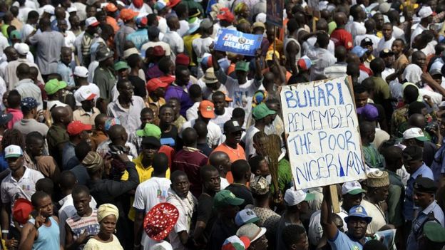 A supporter of Nigeria's leading opposition All Progressive Congress (APC) holds a banner during a campaign rally at the Taslim Balogun Stadium in Lagos on January 30, 2015.