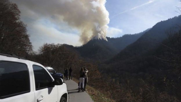 Motorists stop to view the fires ahead of the evacuation order