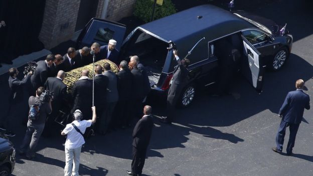 Pallbearers load the coffin onto the hearse - 10 June