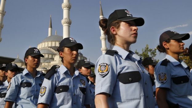 Rows of policewomen in uniform including baseball caps, at a mass funeral in Ankara for a policeman who died in Turkey's failed coup. 18 July 2016.