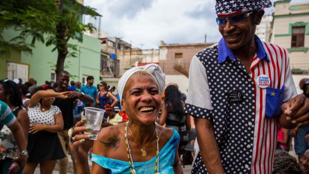 Two Cubans smile widely as they take part in a weekly rumba dance gathering in Havana, Cuba, Saturday, March 19
