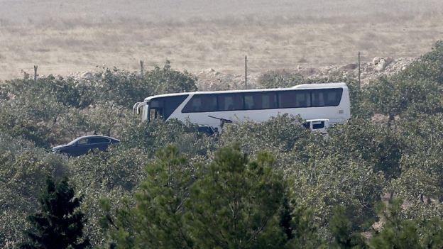 A coach said to be carrying Syrian rebels stands in Karkamis, near Turkey's Syrian border, 24 August