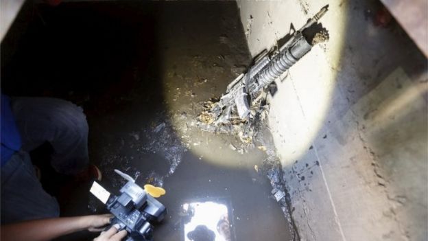 A cameraman films next to a weapon found in a drain from where Joaquin 