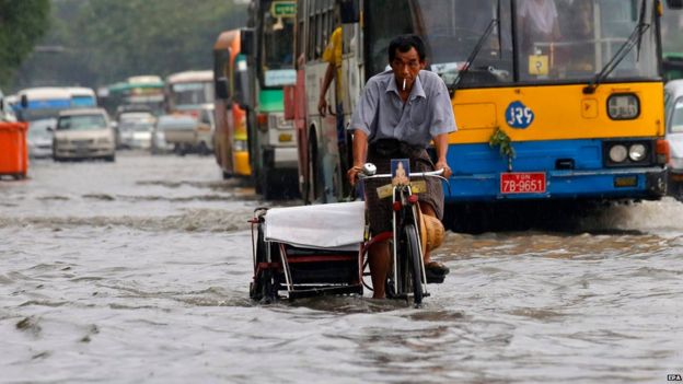 Myanmar man rides a trishaw through a flooded road at downtown area of Yangon, Myanmar, 31 July 2015.