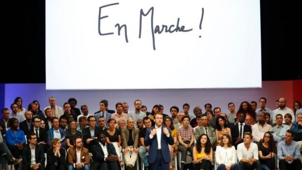 Emmanuel Macron (C) speaks during a public meeting of his political movement 
