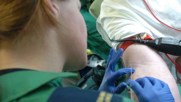 An ambulance staff member giving an injection