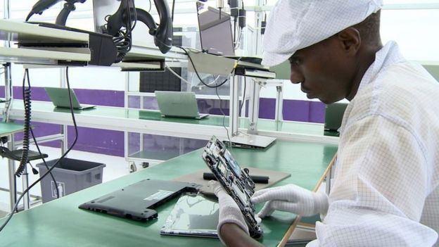 factory worker assembles computer