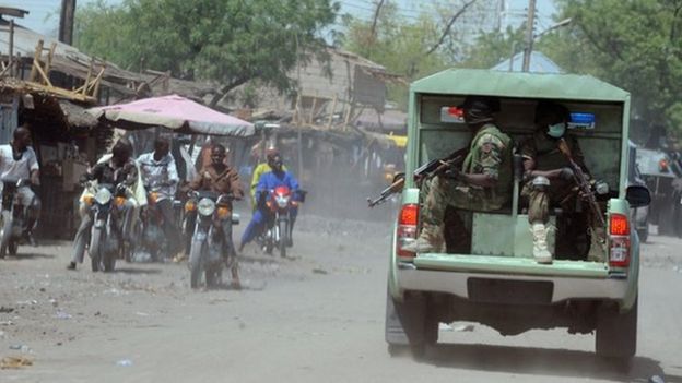 Joint Military Task Force (JTF) patrol the streets of restive north-eastern Nigerian town of Maiduguri, Borno State, on 30 April 2013