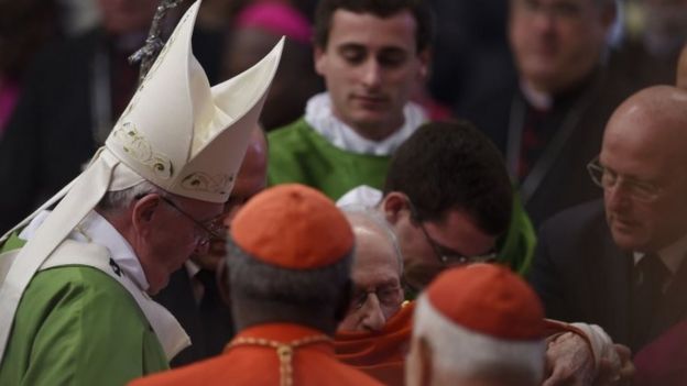 Pope Francis (left) greets cardinals and bishops at the end of a mass for the 14th Ordinary General Assembly of the Synod of Bishops at St Peter's basilica (25 October 2015)