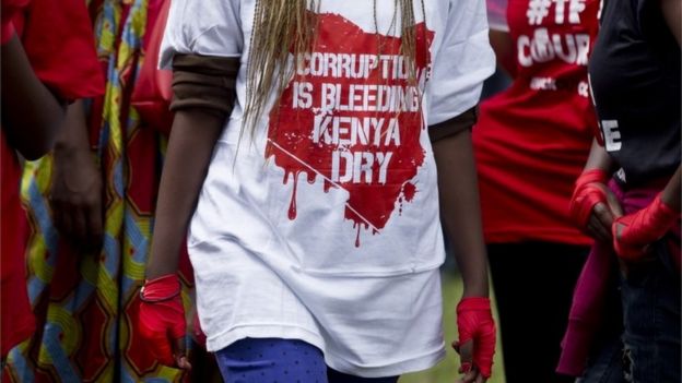 A protester wears red tape on her hands to represent boxing, during an anti-corruption demonstration in downtown Nairobi, Kenya Tuesday, Dec. 1, 2015