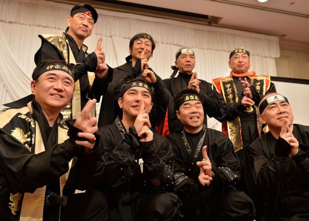 Governors and mayors from Mie, Shiga, Kanagawa prefecture and former tourism agency chief Hiroshi Mizohata (first row, R) pose in ninja costumes for photos as they hold a press conference in Tokyo on 8 March 2015.