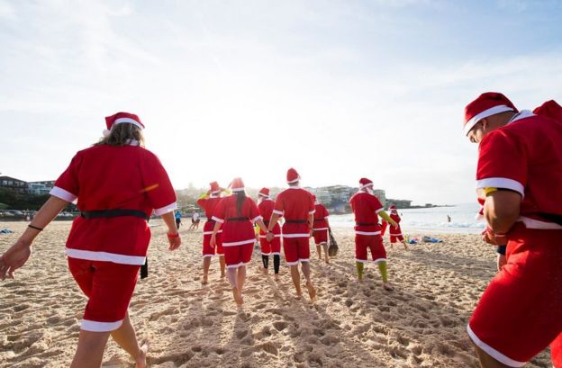 A pack of 320 surfing Santas embrace the Christmas spirit in Australia, breaking the Guinness World Record for the largest surf lesson.